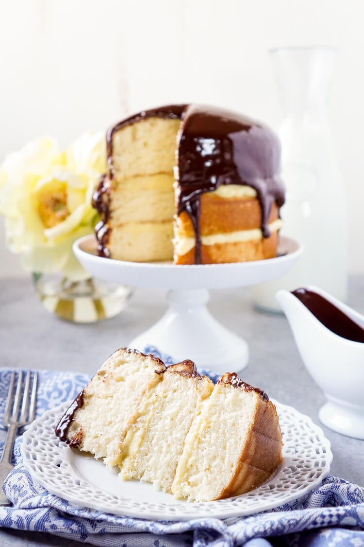 This Triple Layer Boston Cream Pie is a CLASSIC if there ever was one! A rich and wonderful New England dessert! Three layers of fluffy yellow cake with two layers of vanilla bean pastry cream topped with a rich chocolate ganache!