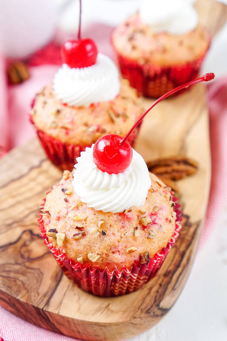 These Cherry Pecan Cream Cheese Muffins are a fun breakfast that borders on dessert! These muffins are loaded with cherry and pecan pieces and filled with a silky cream cheese filling with a hint of almond! Perfect for Valentine's Day or everyday!