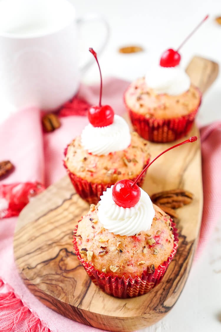 These Cherry Pecan Cream Cheese Muffins are a fun breakfast that borders on dessert! These muffins are loaded with cherry and pecan pieces and filled with a silky cream cheese filling with a hint of almond! Perfect for Valentine's Day or everyday!