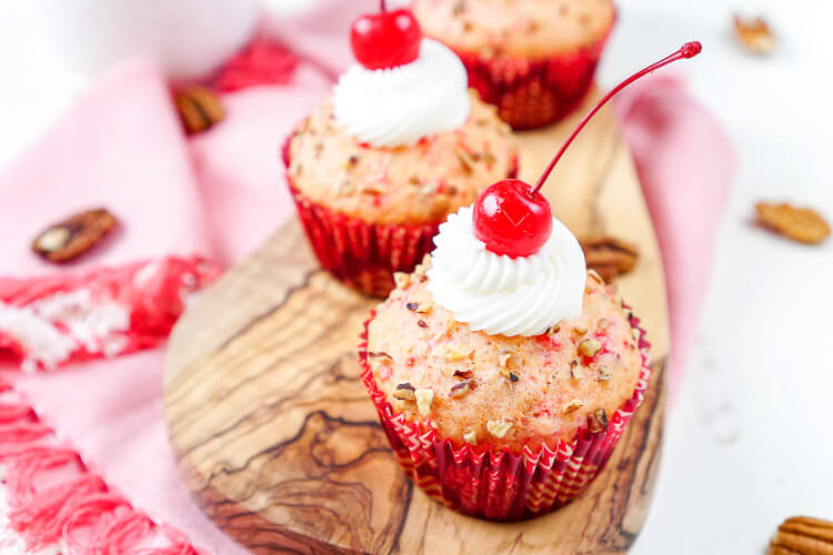 These Cherry Pecan Cream Cheese Muffins are a fun breakfast that borders on dessert! These muffins are loaded with cherry and pecan pieces and filled with a silky cream cheese filling with a hint of almond! Perfect for Valentine's Day or everyday!