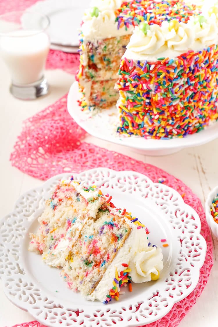 This Funfetti Birthday Cake is made with a fluffy white cake loaded with rainbow sprinkles and wrapped in a white chocolate whipped cream frosting and even more sprinkles!