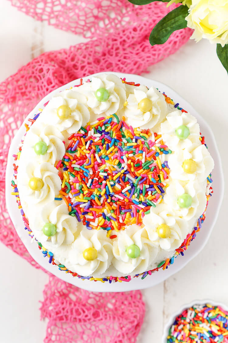 This Funfetti Birthday Cake is made with a fluffy white cake loaded with rainbow sprinkles and wrapped in a white chocolate whipped cream frosting and even more sprinkles!