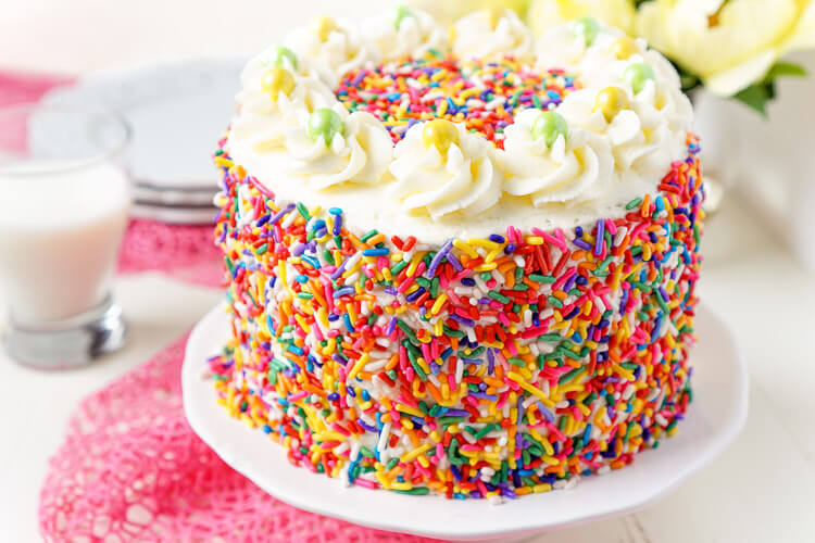 This Funfetti Birthday Cake is made with a fluffy white cake loaded with rainbow sprinkles and wrapped in a white chocolate whipped cream frosting and even more sprinkles!