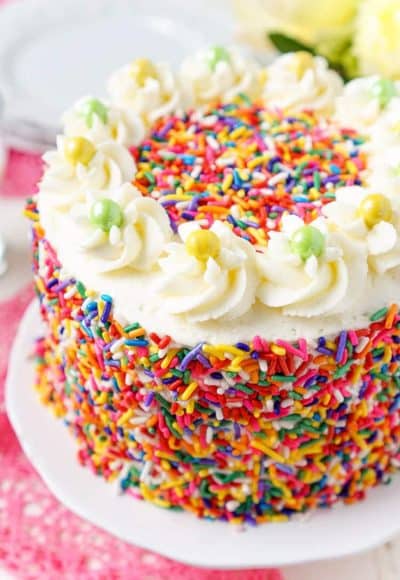 This Funfetti Birthday Cake is made with a fluffy white cake loaded with rainbow sprinkles and wrapped in a white chocolate whipped cream frosting and even more sprinkles!