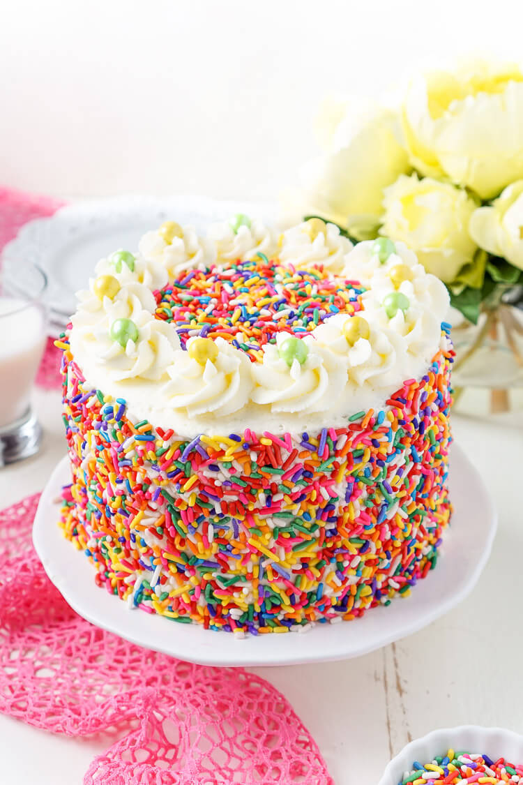 This Funfetti Birthday Cake is made with a fluffy white cake loaded with rainbow sprinkles and wrapped in a white chocolate whipped cream frosting and even more sprinkles!