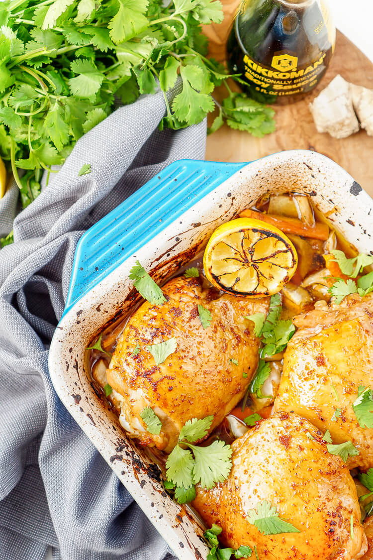 These Lemon Ginger Soy Chicken Thighs are slow roasted, tender, and bursting with flavor! The chicken thighs are basted throughout the roasting process with a simple sauce made with lemon, soy sauce, honey, and ginger. Roasted over a dish of bok choy and carrots, this dish is filled with Asian influence!