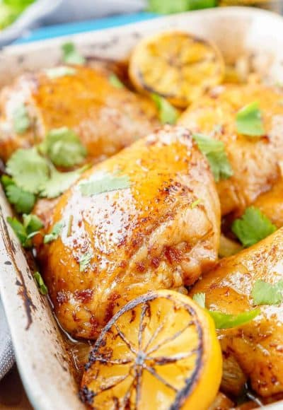 These Lemon Ginger Soy Chicken Thighs are slow roasted, tender, and bursting with flavor! The chicken thighs are basted throughout the roasting process with a simple sauce made with lemon, soy sauce, honey, and ginger. Roasted over a dish of bok choy and carrots, this dish is filled with Asian influence!