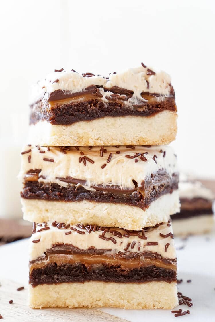 These Billionaire Bars are made with 5 glorious layers of RICH and DECADENT sugary favorites! Shortbread, brownie, caramel, chocolate, and peanut butter frosting combine for the ultimate dessert bar! Everyone will be begging you for the recipe!