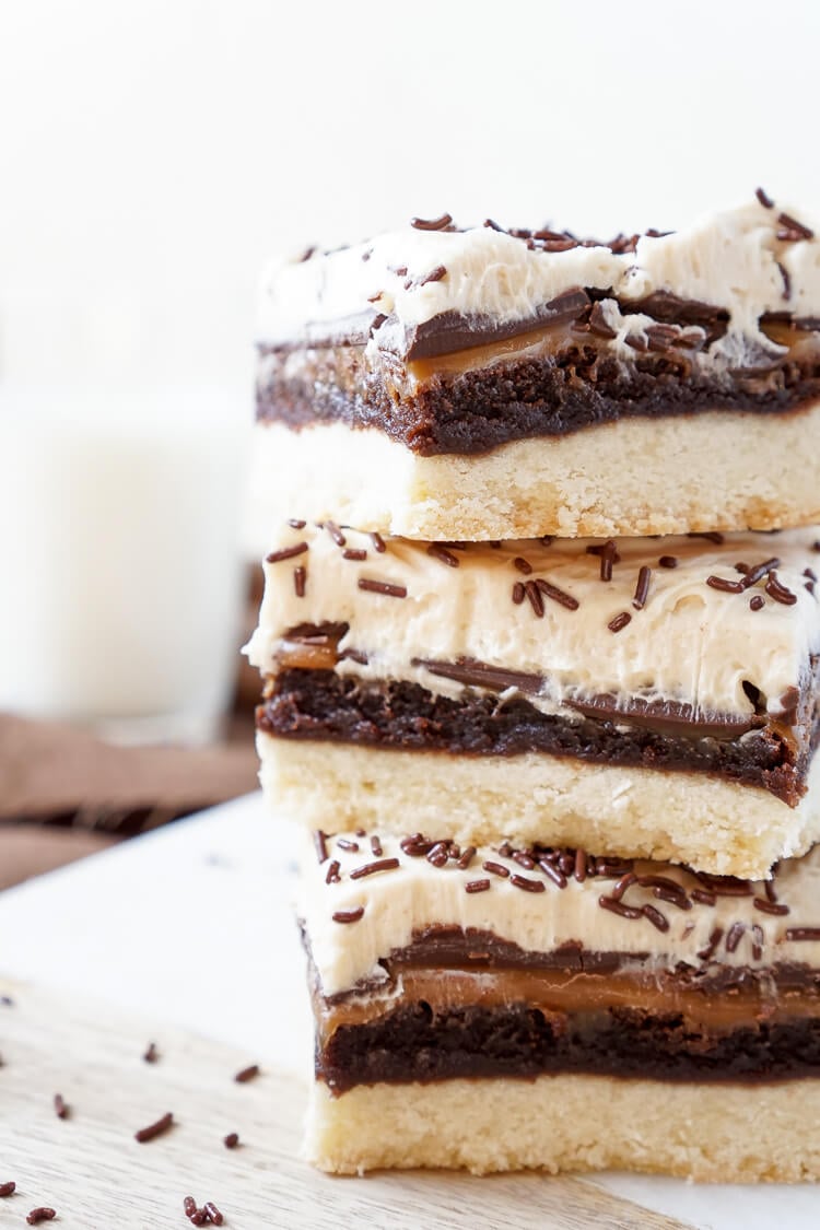 These Billionaire Bars are made with 5 glorious layers of RICH and DECADENT sugary favorites! Shortbread, brownie, caramel, chocolate, and peanut butter frosting combine for the ultimate dessert bar! Everyone will be begging you for the recipe!