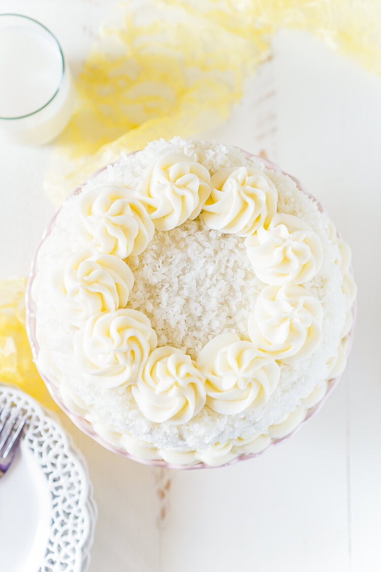 This Classic Coconut Cake is the perfect Easter dessert! Light and fluffy with a cream cheese frosting laced with the essence of sweet coconut!