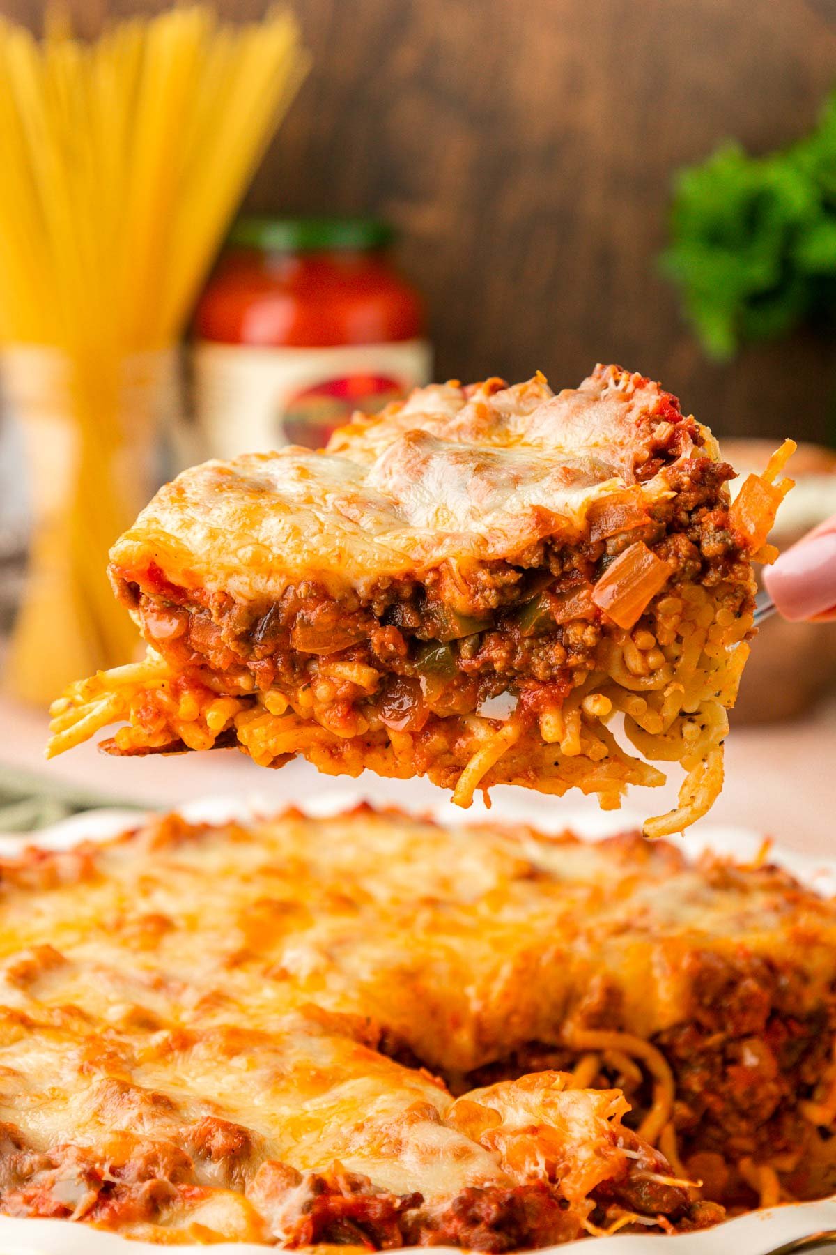 Spaghetti Pie on a spatula being lifted from a pie dish.
