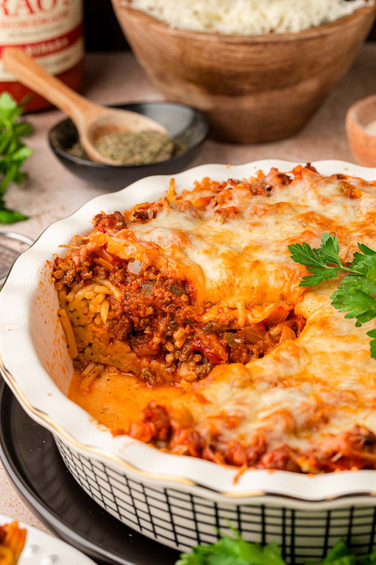 Spaghetti pie missing a piece from the pan.