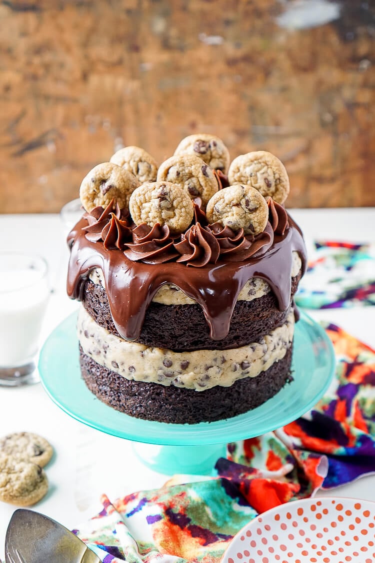 This Chocolate Chip Cookie Dough Cake is made with two layers of delicious chocolate cake and two layers of edible cookie dough then topped with ganache, frosting and mini chocolate chip cookies!