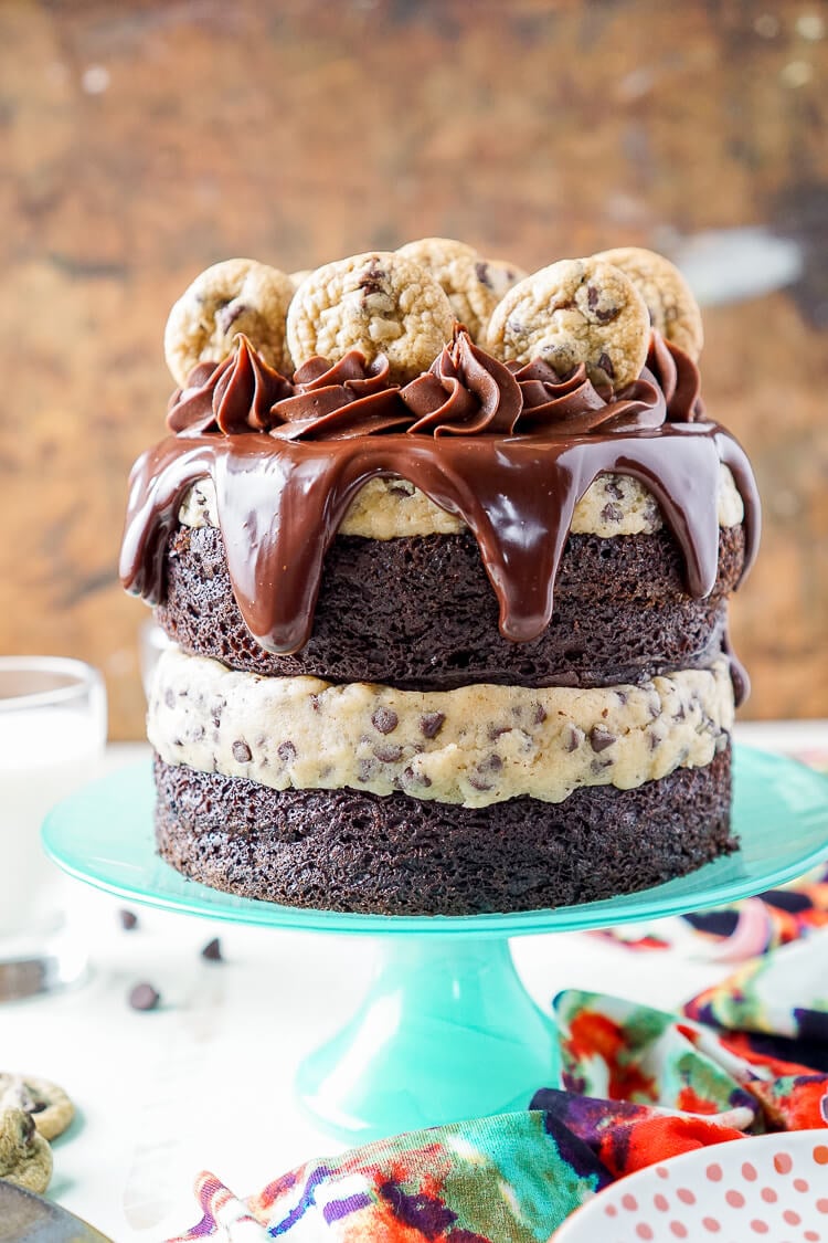 This Chocolate Chip Cookie Dough Cake is made with two layers of delicious chocolate cake and two layers of edible cookie dough then topped with ganache, frosting and mini chocolate chip cookies!