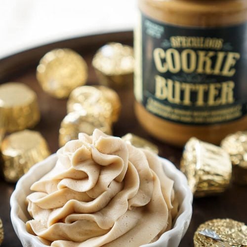 Cookie Butter Frosting in a bowl in front of a jar of Cookie Butter