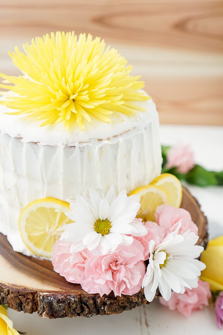 An Earl Grey layer cake with lemon frosting decorated with flowers.