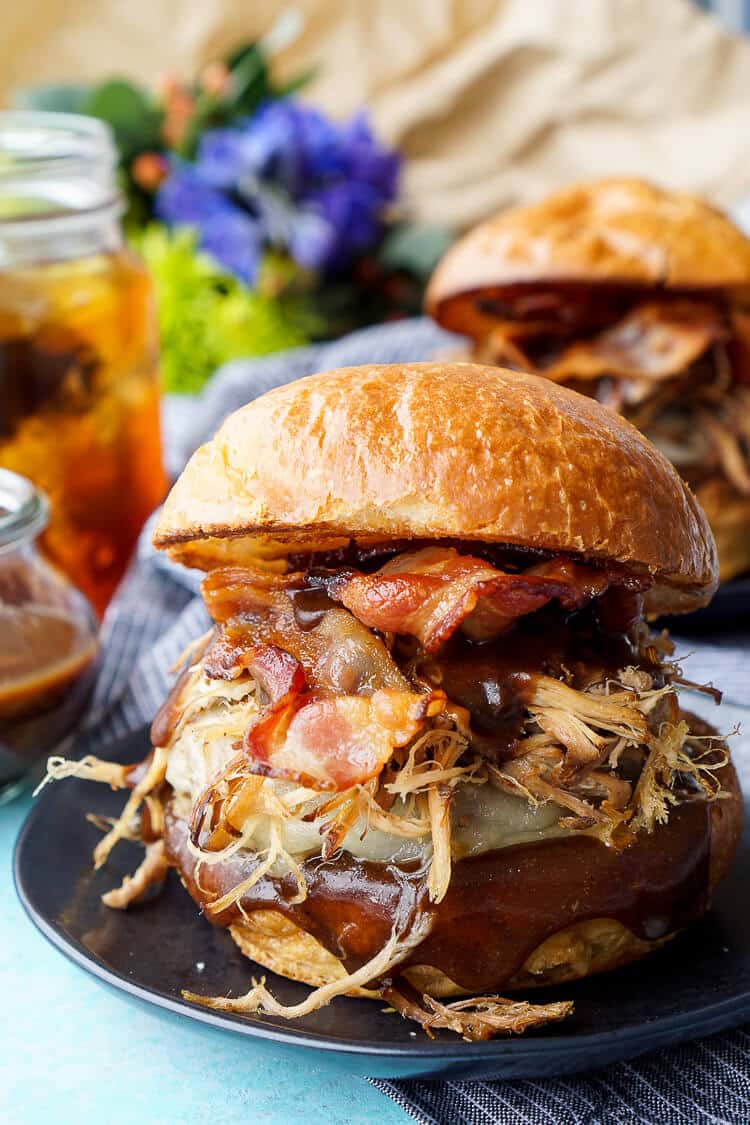 This Meat Lovers Cheeseburger is loaded up with a burger, pulled pork, and bacon! Topped with cheese and a sweet and tangy sauce, it's the ultimate burger!