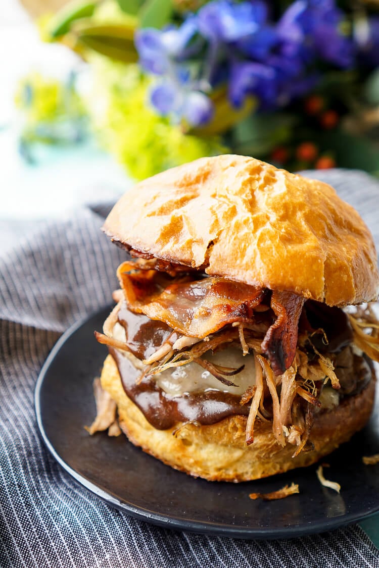 This Meat Lovers Cheeseburger is loaded up with a burger, pulled pork, and bacon! Topped with cheese and a sweet and tangy sauce, it's the ultimate burger!