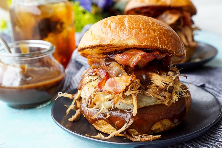 This Meat Lovers Cheeseburger is loaded up with a burger, pulled pork, and bacon! Topped with cheese and a sweet and tangy sauce, it's the ultimate burger!