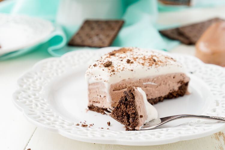 This Skinny Ice Cream Cake is everything you love about the classic dessert, but lighter! A layer of chocolate graham cracker is topped with a creamy chocolate center and topped with whipped topping for a cold summer treat everyone will love!