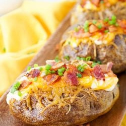 These are the Best Ever Baked Potatoes, from the prep work to the toppings, they're perfectly seasoned and loaded up with a creamy dressing, cheddar cheese, bacon, and chives!