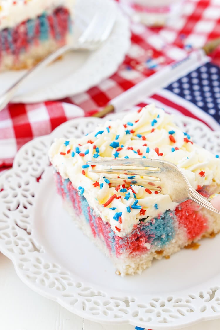 This Red, White, and Blue Marble Sheet Cake is made with an adapted cake box mix and topped with a whipped white chocolate frosting. It's the perfect patriotic dessert for the 4th of July!