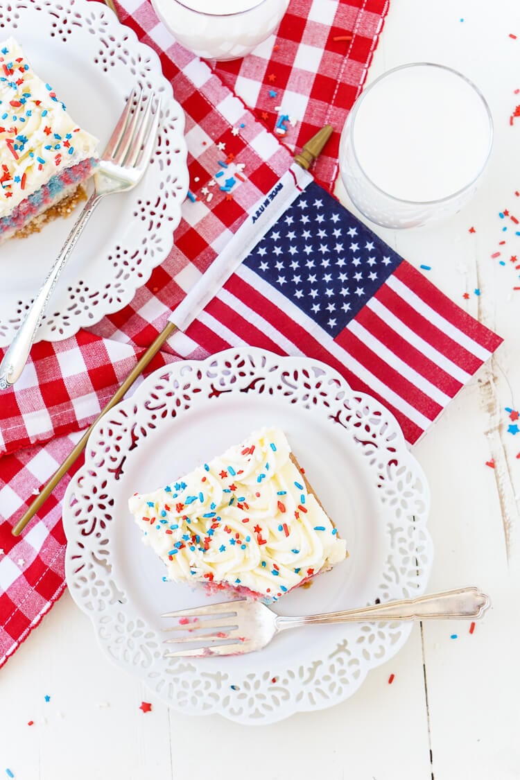 This Red, White, and Blue Marble Sheet Cake is made with an adapted cake box mix and topped with a whipped white chocolate frosting. It's the perfect patriotic dessert for the 4th of July!