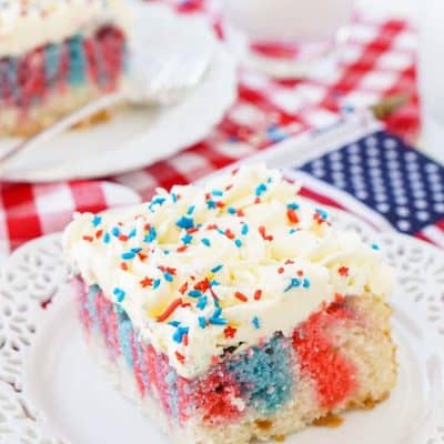 This Red, White, and Blue Marble Sheet Cake is made with an adapted cake box mix and topped with a whipped white chocolate frosting. It's the perfect patriotic dessert for the 4th of July!