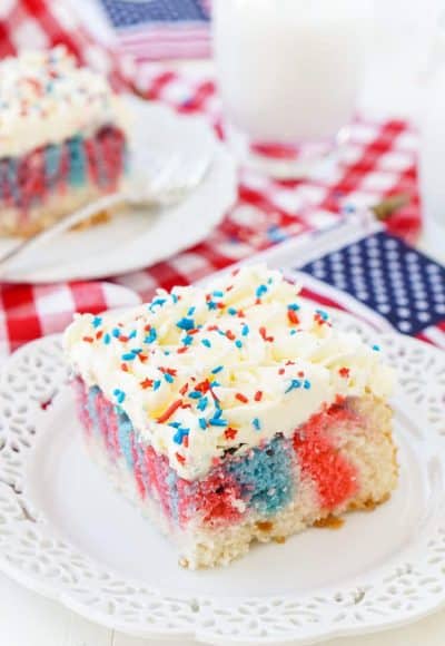 This Red, White, and Blue Marble Sheet Cake is made with an adapted cake box mix and topped with a whipped white chocolate frosting. It's the perfect patriotic dessert for the 4th of July!