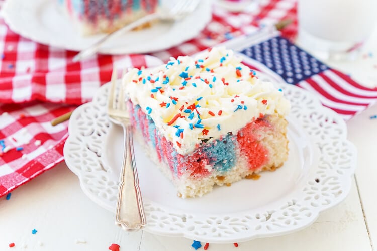 This Red, White, and Blue Marble Sheet Cake is made with an adapted cake box mix and topped with a whipped white chocolate frosting. It's the perfect patriotic dessert for the 4th of July!