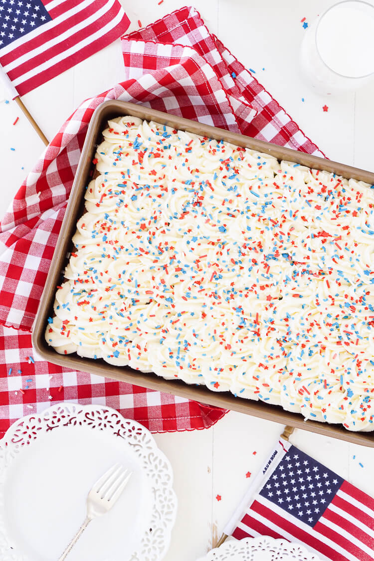 This Red, White, and Blue Marble Sheet Cake is made with an adapted cake box mix and topped with a whipped white chocolate frosting. It's the perfect patriotic dessert for the 4th of July!