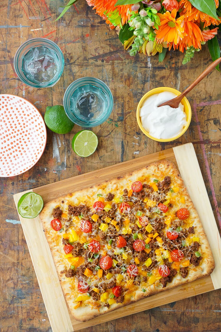 Mix up your Taco Tuesday menu with this Taco Pizza, it's everything you love about the classic weeknight meal on a delicious flatbread for a quick and easy dinner idea the whole family will love!