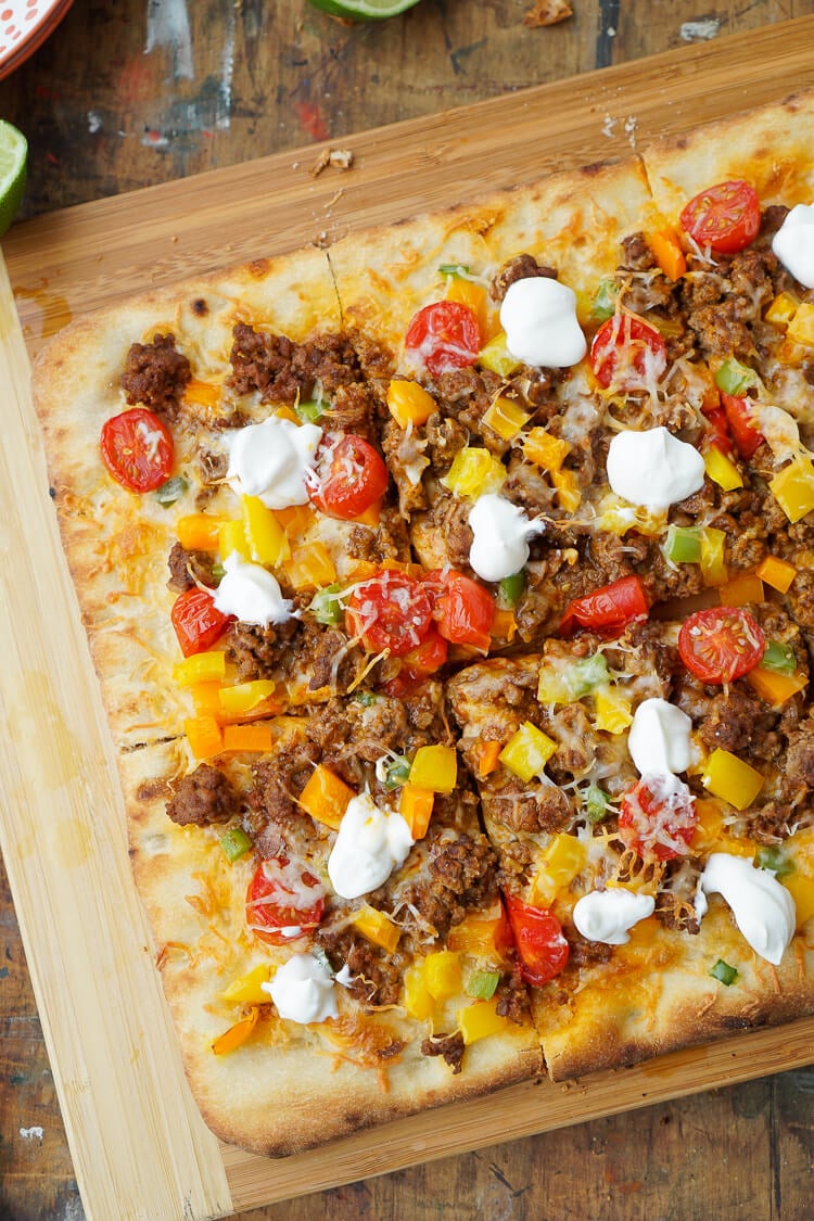 Mix up your Taco Tuesday menu with this Taco Pizza, it's everything you love about the classic weeknight meal on a delicious flatbread for a quick and easy dinner idea the whole family will love!