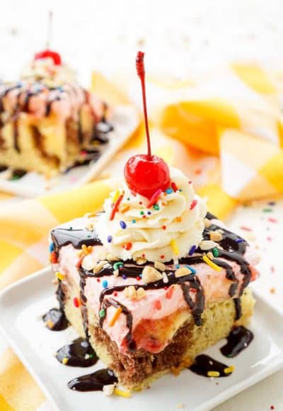 This Banana Split Cake will be the most fun dessert you'll make all summer! Layers of chocolate, vanilla, strawberry, banana, and the list goes on! Your family will beg you to make it again!