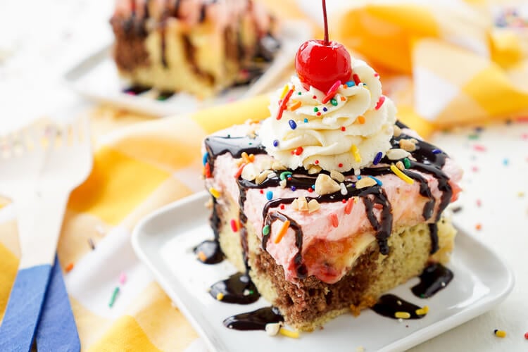 This Banana Split Cake will be the most fun dessert you'll make all summer! Layers of chocolate, vanilla, strawberry, banana, and the list goes on! Your family will beg you to make it again!