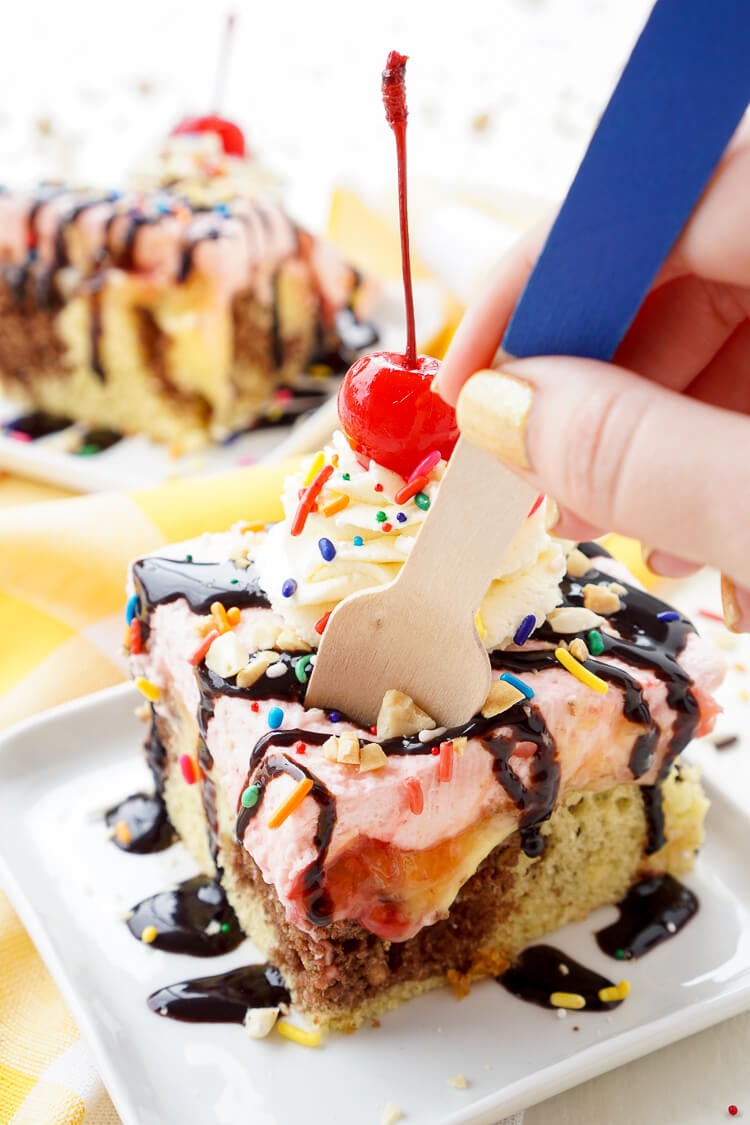 This Banana Split Cake will be the most fun dessert you'll make all summer! Layers of chocolate, vanilla, strawberry, banana, and the list goes on! Your family will beg you to make it again!