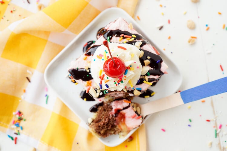 This Banana Split Cake will be the most fun dessert you'll make all summer! Layers of chocolate, vanilla, strawberry, banana, and the list goes on! Your family will beg you to make it again!