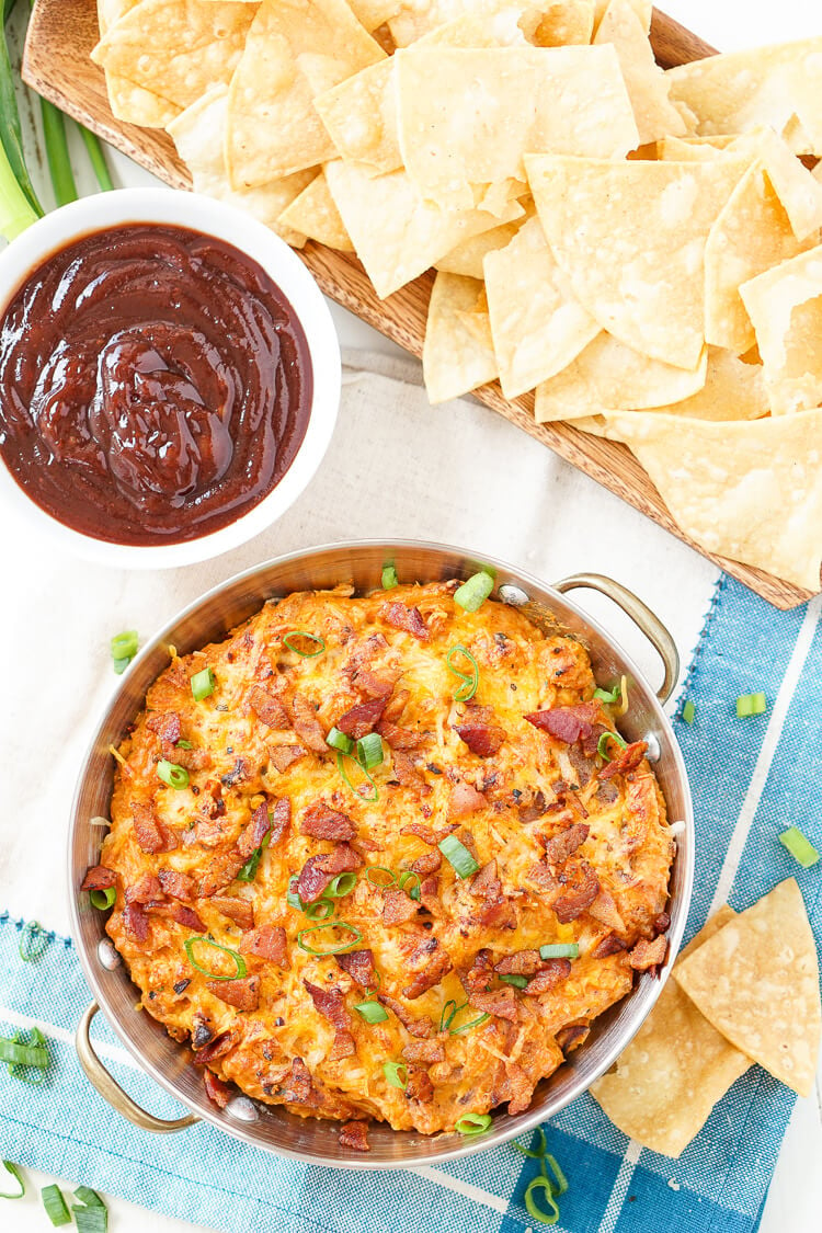 This Cheesy Bacon BBQ Chicken Dip will be the winning dish at your next game day party! Cheesy goodness loaded up with caramelized onions, crunchy bacon, shredded chicken, and tangy barbecue sauce! Only 10 minutes of prep!