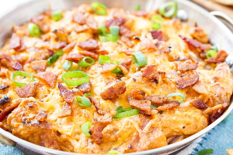 This Cheesy Bacon BBQ Chicken Dip will be the winning dish at your next game day party! Cheesy goodness loaded up with caramelized onions, crunchy bacon, shredded chicken, and tangy barbecue sauce! Only 10 minutes of prep!