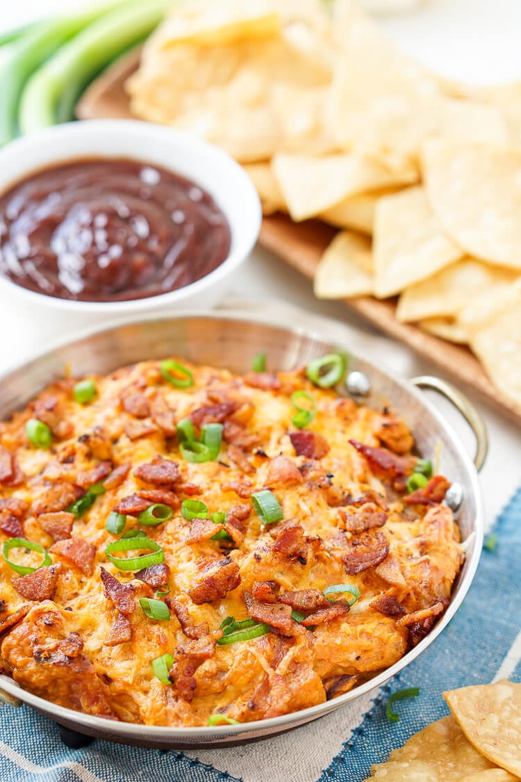 This Cheesy Bacon BBQ Chicken Dip will be the winning dish at your next game day party! Cheesy goodness loaded up with caramelized onions, crunchy bacon, shredded chicken, and tangy barbecue sauce! Only 10 minutes of prep!