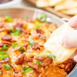 This Cheesy Bacon BBQ Chicken Dip will be the winning dish at your next game day party! Cheesy goodness loaded up with caramelized onions, crunchy bacon, shredded chicken, and tangy barbecue sauce! Only 10 minutes of prep!