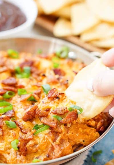 This Cheesy Bacon BBQ Chicken Dip will be the winning dish at your next game day party! Cheesy goodness loaded up with caramelized onions, crunchy bacon, shredded chicken, and tangy barbecue sauce! Only 10 minutes of prep!