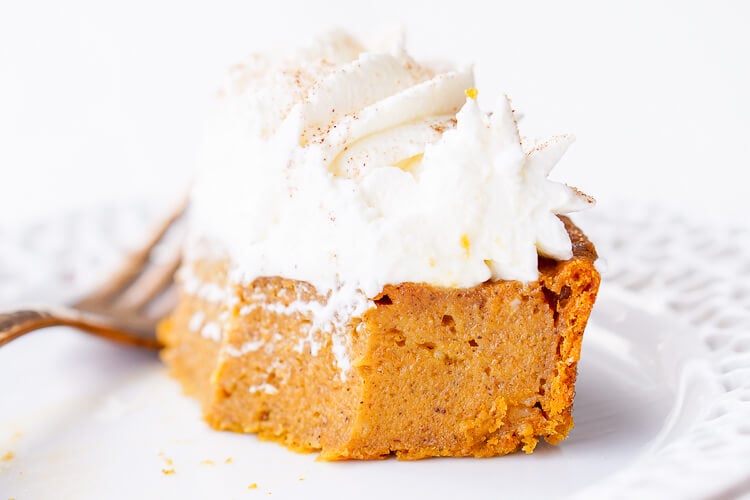 This Impossible Pumpkin Pie Recipe is actually the easiest pumpkin pie you'll ever make! As it bakes, it forms a light crust on its own and leaves behind a dense, but creamy pumpkin filling. Top it with whipped cream and it's the perfect fall dessert!