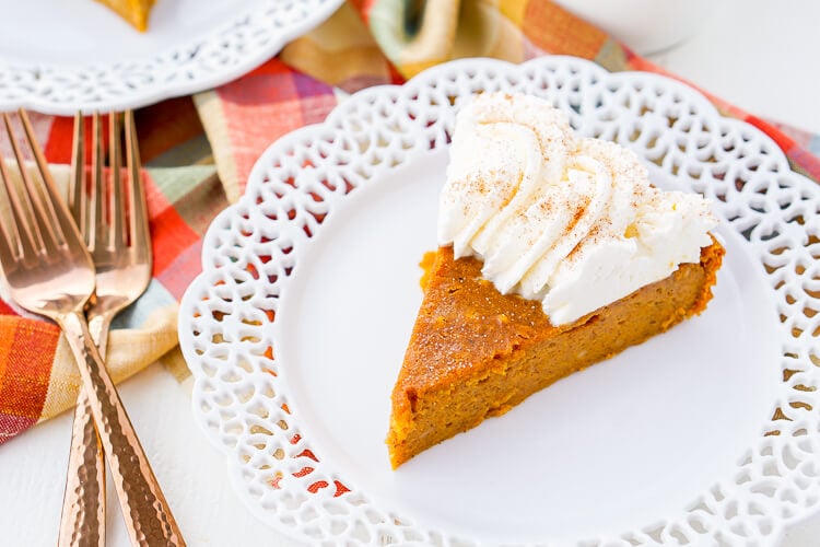 This Impossible Pumpkin Pie Recipe is actually the easiest pumpkin pie you'll ever make! As it bakes, it forms a light crust on its own and leaves behind a dense, but creamy pumpkin filling. Top it with whipped cream and it's the perfect fall dessert!