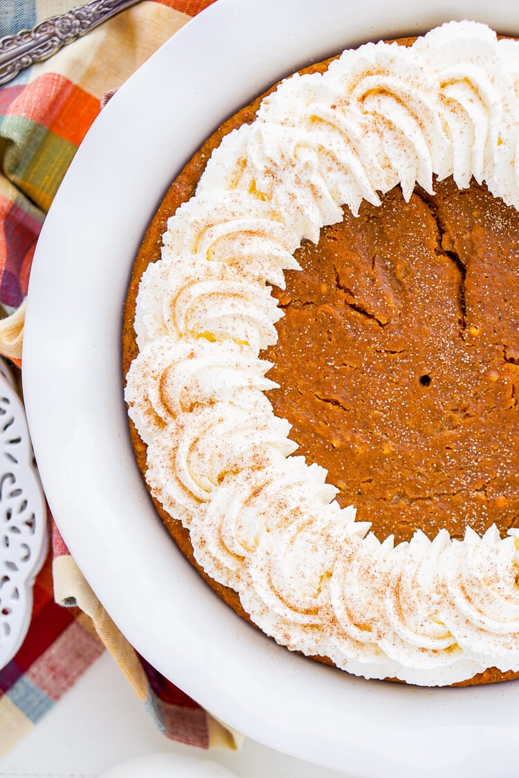 This Impossible Pumpkin Pie Recipe is actually the easiest pumpkin pie you'll ever make! As it bakes, it forms a light crust on its own and leaves behind a dense, but creamy pumpkin filling. Top it with whipped cream and it's the perfect fall dessert!