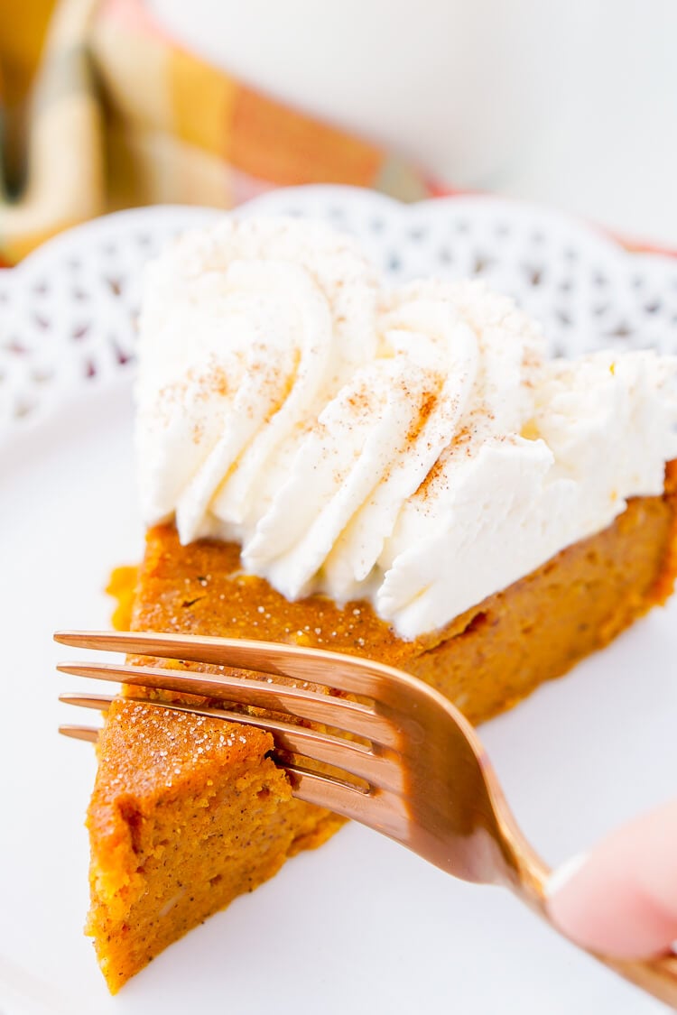 This Impossible Pumpkin Pie Recipe is actually the easiest pumpkin pie you'll ever make! As it bakes, it forms a light crust on its own and leaves behind a dense, but creamy pumpkin filling. Top it with whipped cream and it's the perfect fall dessert!