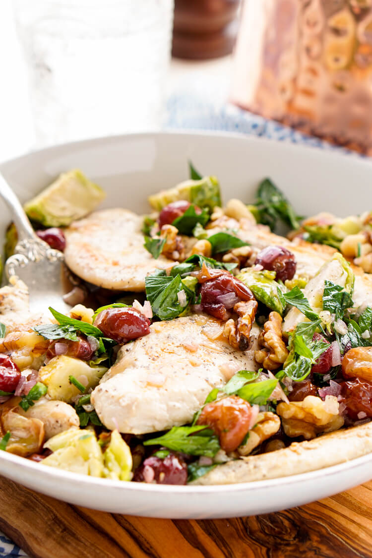 This Chicken Dinner is loaded with seasonal flavors and comes together in just 30 minutes! Roasted Brussels sprouts and red grapes mixed with shallots and garlic and the crunch of walnuts bring this whole meal to life!