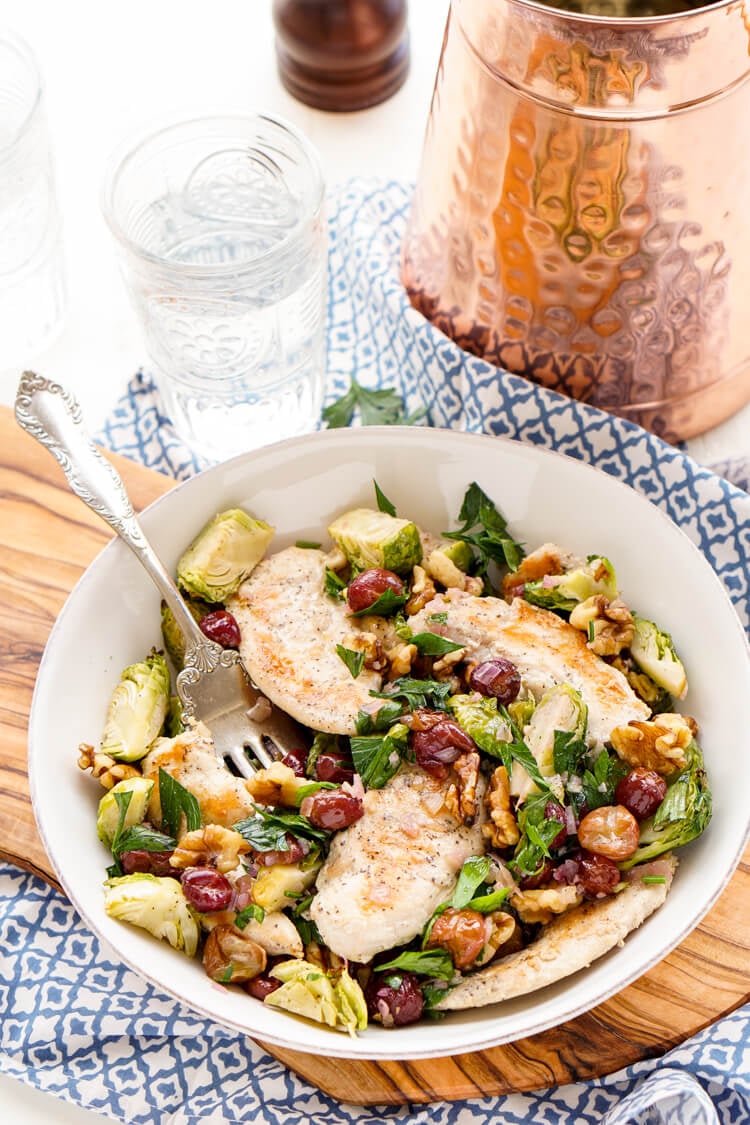 This Chicken Dinner is loaded with seasonal flavors and comes together in just 30 minutes! Roasted Brussels sprouts and red grapes mixed with shallots and garlic and the crunch of walnuts bring this whole meal to life!