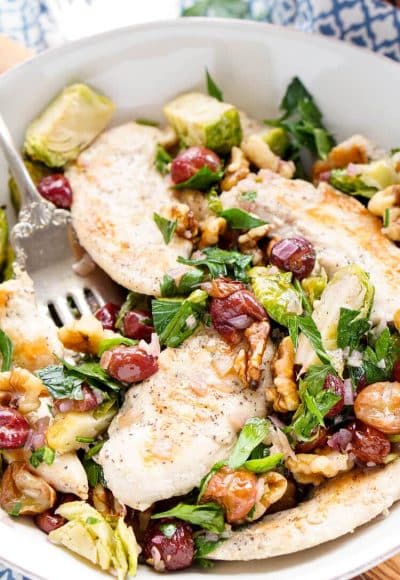 This Chicken Dinner is loaded with seasonal flavors and comes together in just 30 minutes! Roasted Brussels sprouts and red grapes mixed with shallots and garlic and the crunch of walnuts bring this whole meal to life!