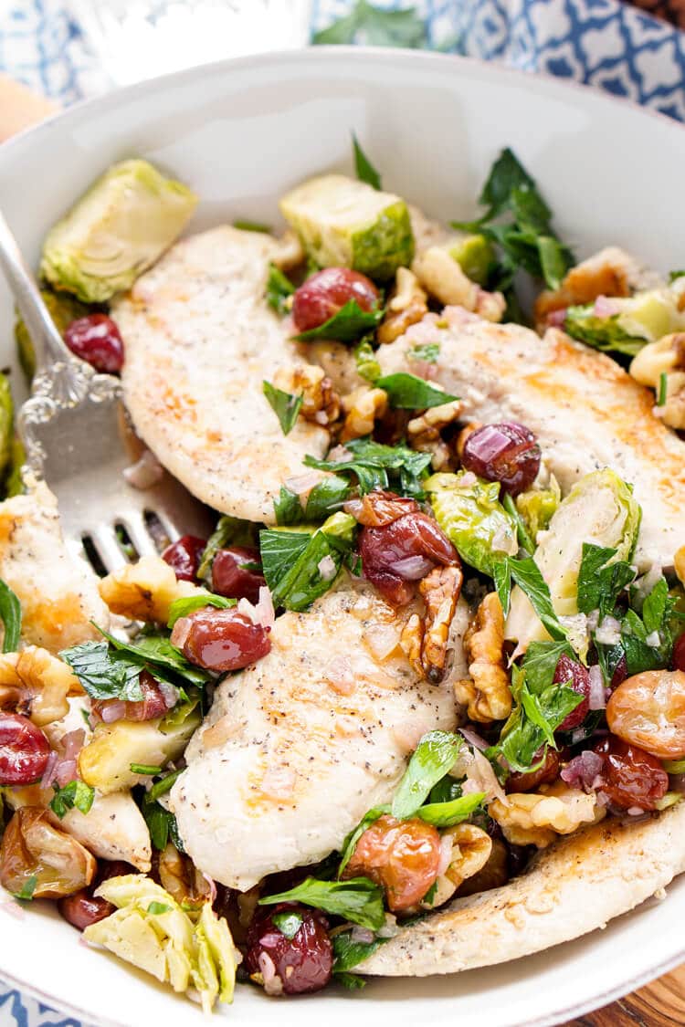 This Chicken Dinner is loaded with seasonal flavors and comes together in just 30 minutes! Roasted Brussels sprouts and red grapes mixed with shallots and garlic and the crunch of walnuts bring this whole meal to life!